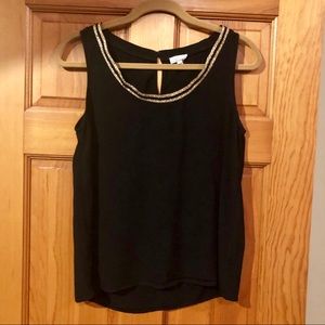 Black sleeveless top with gold neckline
